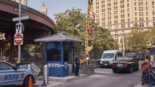 A police officer stands guard outside One Police Plaza NYPD Headquarters on Friday, Sept. 13, 2024, in New York. (AP Photo/Andres Kudacki)