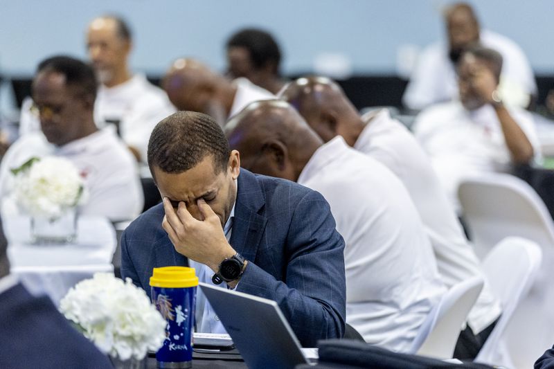 Participants pray during opening statements at the inaugural conference of the Greater Atlanta Black Men's Congress at Mount Ephraim Baptist Church in Atlanta, Saturday, July 13, 2024. (Steve Schaefer/AJC)