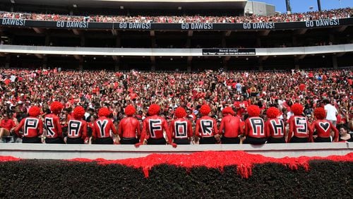 The UGA Paint Line displays a message of support for Apalachee High School during the first half in an NCAA football game against Tennessee Tech at Sanford Stadium, Saturday, September 9, 2024, in Athens.  Four people were killed and multiple others were injured in a shooting at the high school on Wednesday. (Hyosub Shin / AJC)