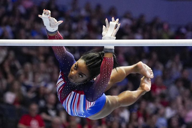 Simone Biles competes on the uneven bars at the United States Gymnastics Olympic Trials on Sunday, June 30, 2024, in Minneapolis. (AP Photo/Abbie Parr)
