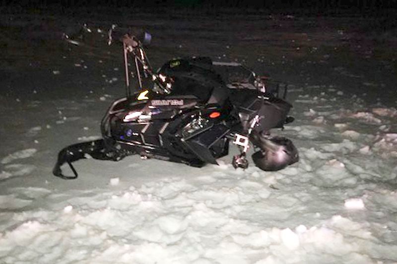 FILE - This U.S. Army photograph by attorney Douglas Desjardins shows a damaged snowmobile which crashed with a Black Hawk helicopter, March 13, 2019, in Worthington, Mass. (U.S. Army photograph provided by attorney Douglas Desjardins via AP, File)