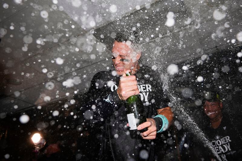 New York Yankees' Aaron Judge celebrates clinching a playoff spot after a 2-1 win in 10 innings over the Seattle Mariners in a baseball game Wednesday, Sept. 18, 2024, in Seattle. (AP Photo/Lindsey Wasson)