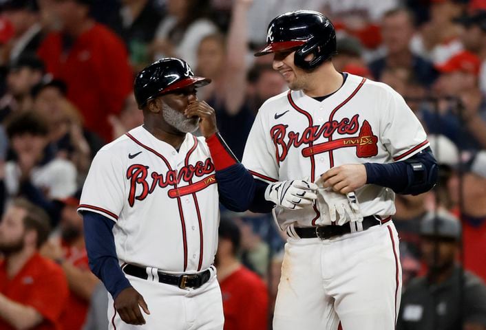 Atlanta Braves third baseman Austin Riley (27) smiles at first base after an RBI single against the Philadelphia Phillies during the sixth inning of game two of the National League Division Series at Truist Park in Atlanta on Wednesday, October 12, 2022. (Jason Getz / Jason.Getz@ajc.com)