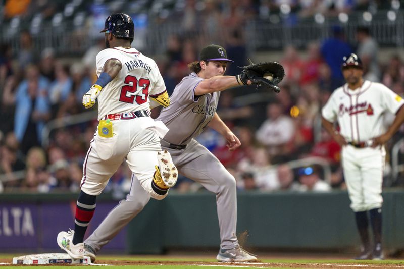 Colorado Rockies first baseman Michael Toglia, center, catches the throw as Atlanta Braves' Michael Harris II (23) is forced out at first base in the fifth inning of a baseball game, Thursday, Sept. 5, 2024, in Atlanta. (AP Photo/Jason Allen)