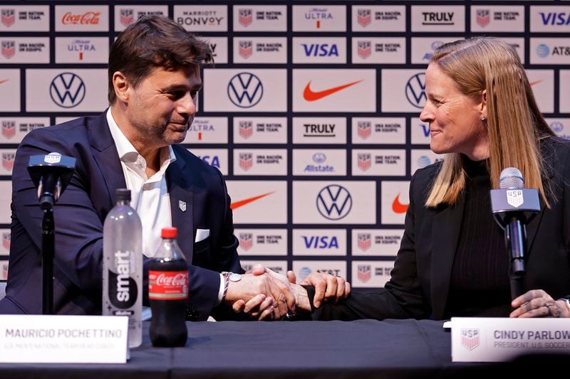 Mauricio Pochettino, left, the newly appointed head coach of the United States men's national soccer team, shakes hands with U.S. Soccer Federation President Cindy Parlow Cone at a press conference Friday, Sept. 13, 2024, in New York. (AP Photo/Adam Hunger)