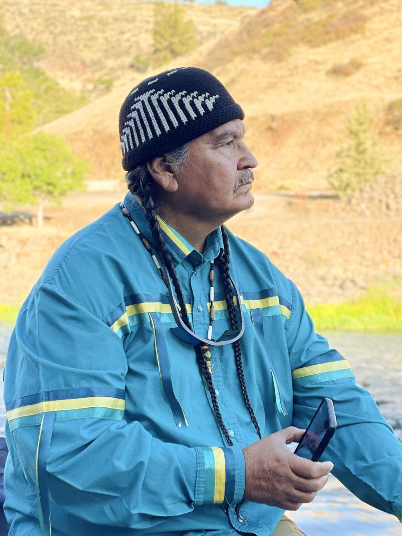 In this image provided by Dale Meurer, former Klamath Tribes Chairman Jeff Mitchell watches as construction crews remove the final cofferdam that was left of Iron Gate Dam, allowing the Klamath River to flow through on Aug. 28, 2024, near Hornbrook, Calif. (Dale Meurer via AP)