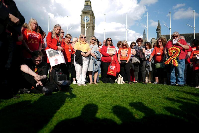 Infected blood campaigners gather in Parliament Square, ahead of the publication of the final report into the scandal, in London, Sunday, May 19, 2024. The final report of the U.K.’s infected blood inquiry will be published Monday, six years after it started its work. The inquiry heard evidence as to how thousands of people contracted HIV or hepatitis from transfusions of tainted blood and blood products in the 1970s and 1980s. (Aaron Chown/PA via AP)