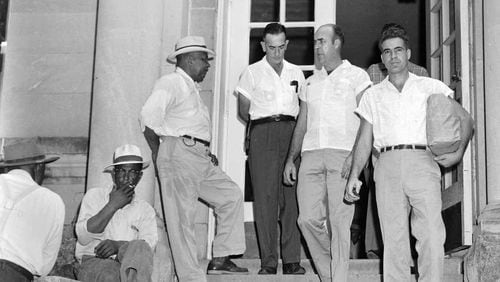 Roy Bryant, right, and J. W. Milam, second from right, walk down the steps of the Leflore County Courthouse in Greenwood, Miss., on Sept. 30, 1955, after being freed on bond in the kidnapping and murder of Emmett Till. Bryant and Milam eventually were acquitted of murdering the 14-year-old black youth in a trial which drew international attention. (AP Photo/File)