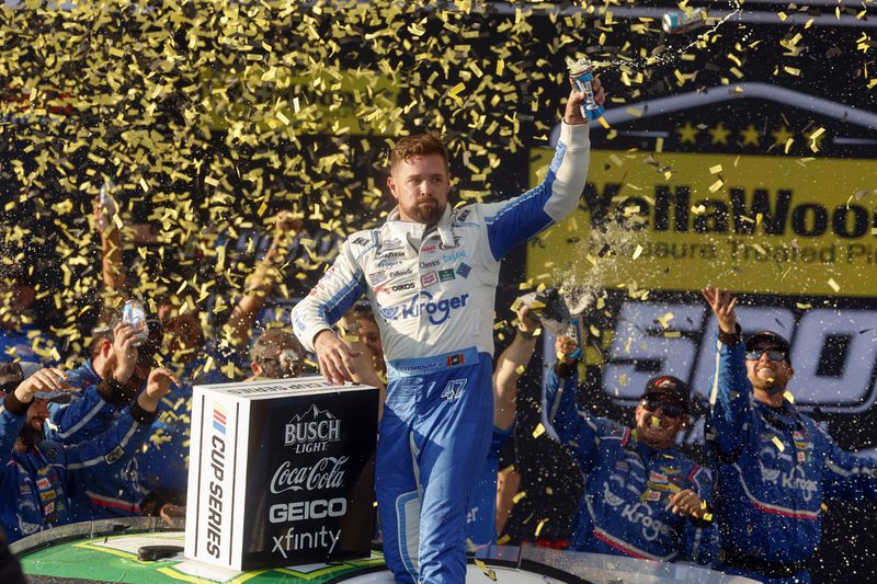 Driver Ricky Stenhouse Jr. celebrates in Victory Lane after a NASCAR Cup Series auto race at Talladega Superspeedway, Sunday, Oct. 6, 2024, in Talladega, Ala. (AP Photo/ Butch Dill)