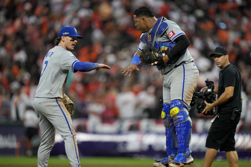 Kansas City Royals shortstop Bobby Witt Jr. (7) and catcher Salvador Perez celebrate their team's win over the Baltimore Orioles after Game 1 of an AL Wild Card Series baseball game, Tuesday, Oct. 1, 2024, in Baltimore. (AP Photo/Stephanie Scarbrough)