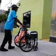 Robert Robinson, 61, who is homeless, pushes his belongings down the street on the first day of a statute that took effect, making it illegal in Florida to sleep on sidewalks, in parks, on beaches or in other public spaces — one of the country's strictest anti-homelessness laws, Tuesday, Oct. 1, 2024, in Fort Lauderdale, Fla. (AP Photo/Lynne Sladky)