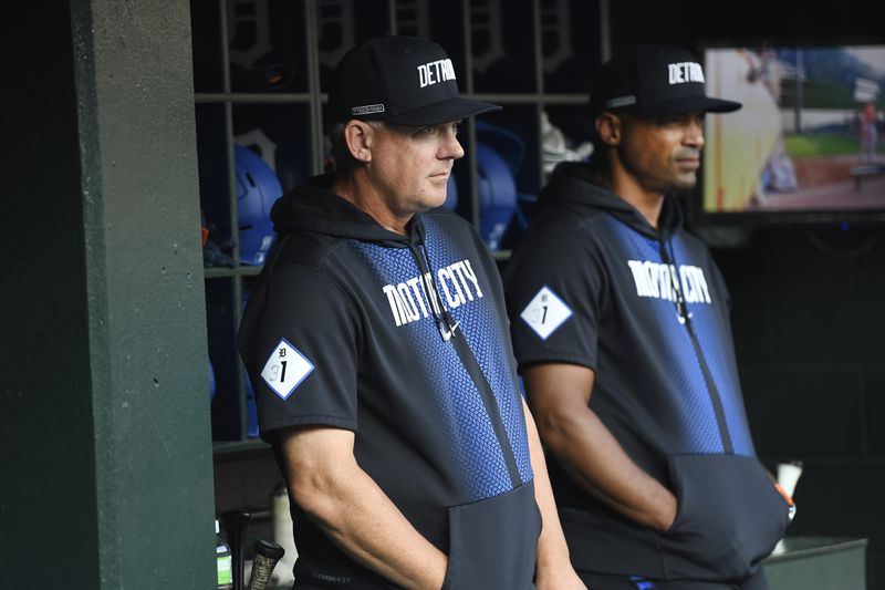 Detroit Tigers manager A.J. Hinch, left, and bench coach George Lombard, right, watch from the dugout before a baseball game against the Baltimore Orioles, Friday, Sept. 13, 2024, in Detroit. (AP Photo/Jose Juarez)