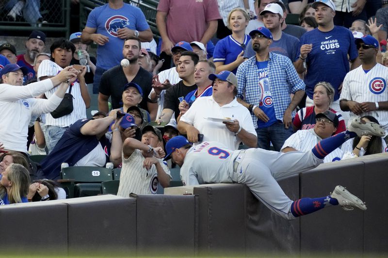 New York Mets left fielder Brandon Nimmo (9) can't make the play on a foul ball by Chicago Cubs' Cody Bellinger during the sixth inning of a baseball game in Chicago, Sunday, June 23, 2024. (AP Photo/Nam Y. Huh)