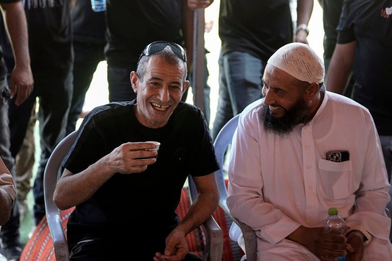 Qaid Farhan Alkadi, 52, who was held hostage by Hamas militants in Gaza Strip, drinks a coffee after arriving in the Khirbet Karkur village, near Rahat, southern Israel, Wednesday, Aug. 28, 2024. (AP Photo/Mahmoud Illean)