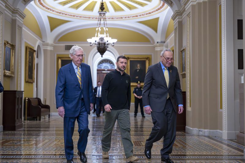 Ukrainian President Volodymyr Zelenskyy, center, walks with Senate Minority Leader Mitch McConnell, R-Ky., left, and Senate Majority Leader Chuck Schumer, D-N.Y., as he arrives for a briefing with lawmakers about the war effort against Russia, at the Capitol in Washington, Thursday, Sept. 26, 2024. (AP Photo/J. Scott Applewhite)