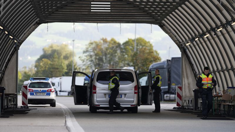 FILE - German federal police officers check a van at the Austrian-German border crossing point in Kiefersfelden, Germany, Oct. 9, 2023. (AP Photo/Matthias Schrader, File)