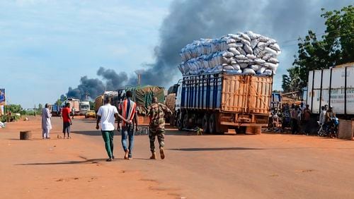 This video grab shows Malian security personnel detaining a man after Mali's army said a military training camp in the capital Bamako has been attacked early Tuesday, Sept. 17 2024. (AP Photo)