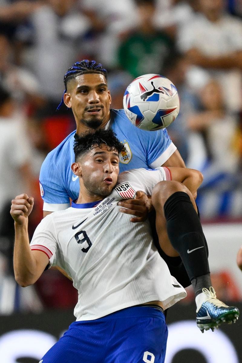 Ricardo Pepi of the United States, front, and Uruguay's Ronald Araujo battle for the ball during a Copa America Group C soccer match in Kansas City, Mo., Monday, July 1, 2024. (AP Photo/Reed Hoffman)