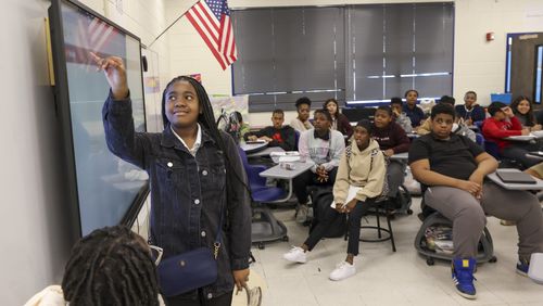 Seventh grade student Skylar Jackson shows her Black History Month project to the classroom at RISE Prep School, on Wednesday, Feb. 22, 2023, in East Point, Ga. The RISE Prep and Grammar schools are in jeopardy of being closed by Fulton County Schools. Jason Getz / Jason.Getz@ajc.com)