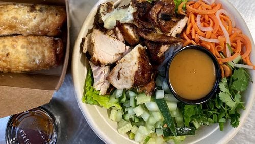 A takeout feast from Pho Cue includes loaded fries dressed up with banh mi toppings, dumplings filled with pork cue, a vermicelli salad with smoked chicken, and insanely good egg rolls with brisket. 
Wendell Brock for The Atlanta Journal-Constitution