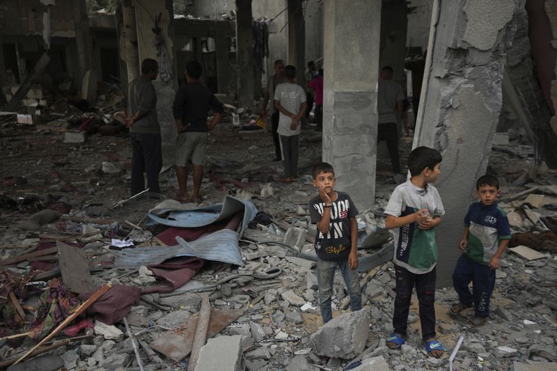 Palestinians examine a destroyed mosque following an Israeli airstrike in Deir al-Balah, Sunday, Oct. 6, 2024. (AP Photo/Abdel Kareem Hana)