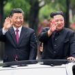 FILE - In this photo released by China's Xinhua News Agency, visiting Chinese President Xi Jinping, left, and North Korean leader Kim Jong Un wave from an open top limousine as they travel along a street in Pyongyang, North Korea, on June 20, 2019. (Ju Peng/Xinhua via AP, File)