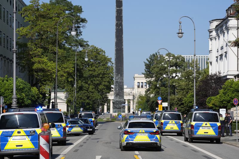 Police officers block a street after police fired shots at a suspicious person near the Israeli Consulate and a museum on the city's Nazi-era history in Munich, Germany, Thursday, Sept. 5, 2024. (AP Photo/Matthias Schrader)