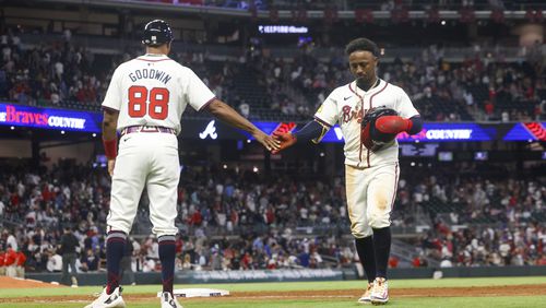 Atlanta Braves second baseman Ozzie Albies greets first base coach Tom Goodwin (88) after the final out to end the game as the Braves lose to the Washington Nationals at Truist Park, Thursday, May 30, 2024, in Atlanta. Albies was on second base. The Braves lost 3-1. (Jason Getz / AJC)
