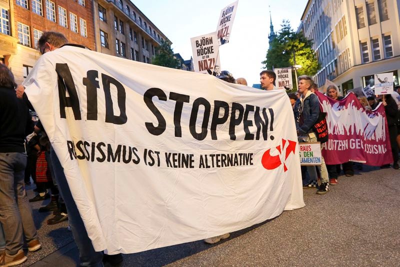 Participants in a demonstration against the right hold a banner with the slogan "Stop AfD! Racism is not an alternative" in Hamburg, Sunday, Sept. 1, 2024. (Bodo Marks/dpa via AP)