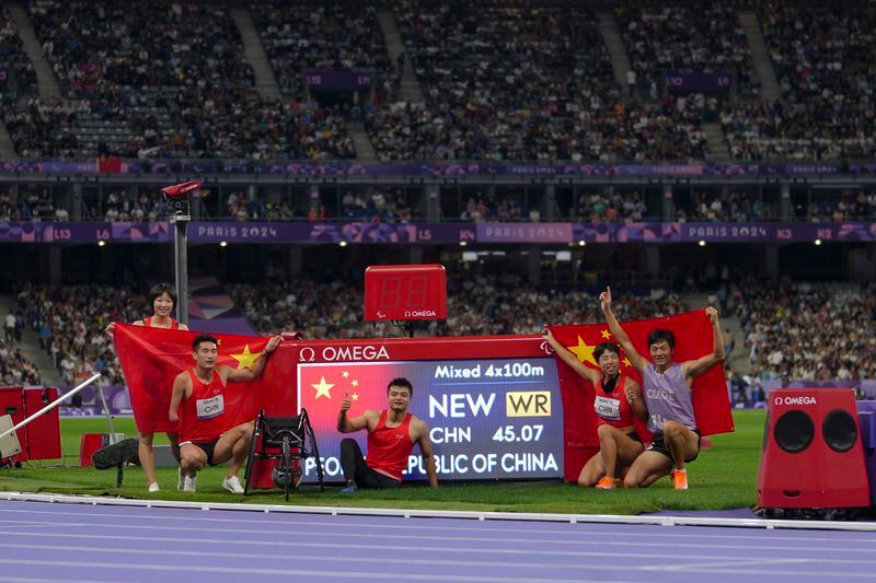 China team poses after winning the gold and setting a new world record in the 4x100 m. universal relay at the 2024 Paralympics, Friday, Sept. 6, 2024, in Paris, France. (AP Photo/Thibault Camus)