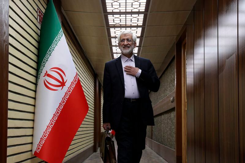 In this picture made available by Iranian state-run TV, IRIB, presidential candidate for June 28, election Saeed Jalili, former Iran's top nuclear negotiator, arrives for a debate of the candidates at the TV studio in Tehran, Iran, Thursday, June 20, 2024. (Morteza Fakhri Nezhad/IRIB via AP)