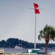 A shrimping boat makes her way back to port as hurricane flags fly at the Davis Islands Yacht Club, Monday, Oct. 7, 2024, in Tampa, Fla. (AP Photo/Chris O'Meara)