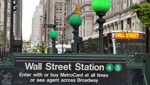 A bus passes the Wall St. subway station on Wednesday, Sept. 18, 2024, in New York. (AP Photo/Peter Morgan)