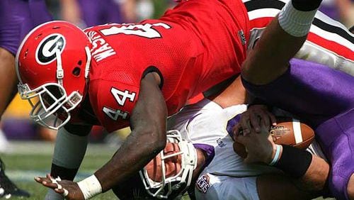 This is Marcus Washington Sr. playing linebacker for the Georgia Bulldogs in 2007. Washington's son of the same name has signed with the Bulldogs 17 years after his father, who is now defensive coordinator and strength and conditioning coach at Grovetown High near Augusta. (Photo by Brant Sanderlin/AJC)