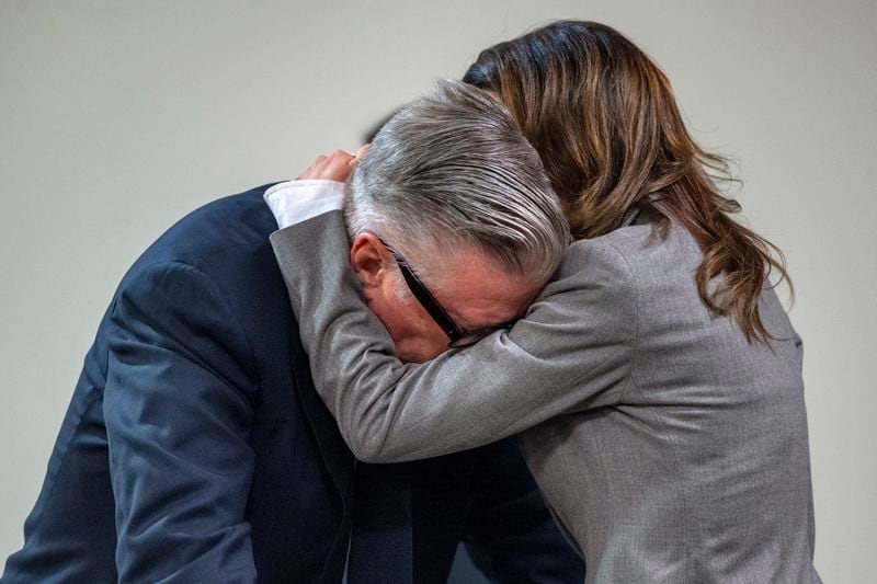 Actor Alec Baldwin, left, reacts as his wife Hilaria hugs him during a break in his trial for involuntary manslaughter for the 2021 fatal shooting of cinematographer Halyna Hutchins during filming of the Western movie "Rust," Friday, July 12, 2024, at Santa Fe County District Court in Santa Fe, N.M. (Eddie Moore/The Albuquerque Journal via AP, Pool)