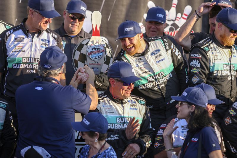 Chris Buescher's (17) team celebrates after winning a NASCAR Cup Series auto race, Sunday, Sept. 15, 2024, in Watkins Glen, N.Y. (AP Photo/Lauren Petracca)