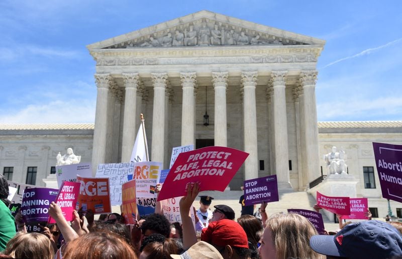 In this file photo, abortion rights activists are seen holding placards during a rally outside the U.S. Supreme Court in Washington.
