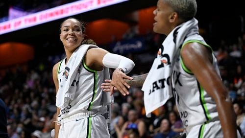 Minnesota Lynx forward Napheesa Collier, left, slaps hands with guard Courtney Williams, right, in the final seconds of a WNBA basketball semifinal game against the Connecticut Sun, Friday, Oct. 4, 2024, in Uncasville, Conn. (AP Photo/Jessica Hill)