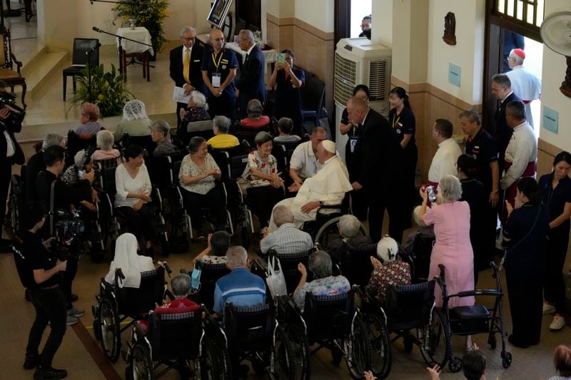 Pope Francis meets with a group of elderly and sick people at the St. Theresa's Home in Singapore, Friday, Sept. 13, 2024. Pope Francis is wrapping up his visit to Singapore by praising its tradition of interfaith harmony. (AP Photo/Gregorio Borgia)