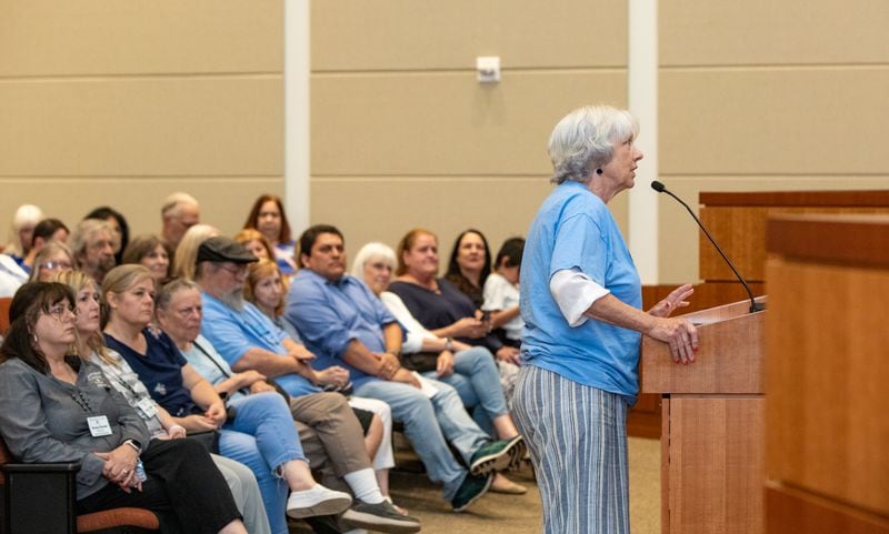 Cherokee County Board of Commissioners listen to Barb Kidders during the public comment portion of the board meeting on Tuesday, June 4, 2024 before the board votes on the structure of the county’s Election Board. The board voted to keep two Democrats and two Republicans on the Election Board. (Jenni Girtman for The Atlanta Journal-Constitution)