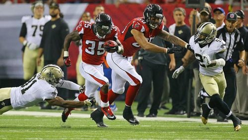 Falcons running back Antone Smith breaks away from Saints safety Jairus Byrd picking up a block from Levine Toilolo for a 54-yard touchdown during the third quarter in their NFL football game on Sunday, Sept. 7, 2014, in Atlanta.