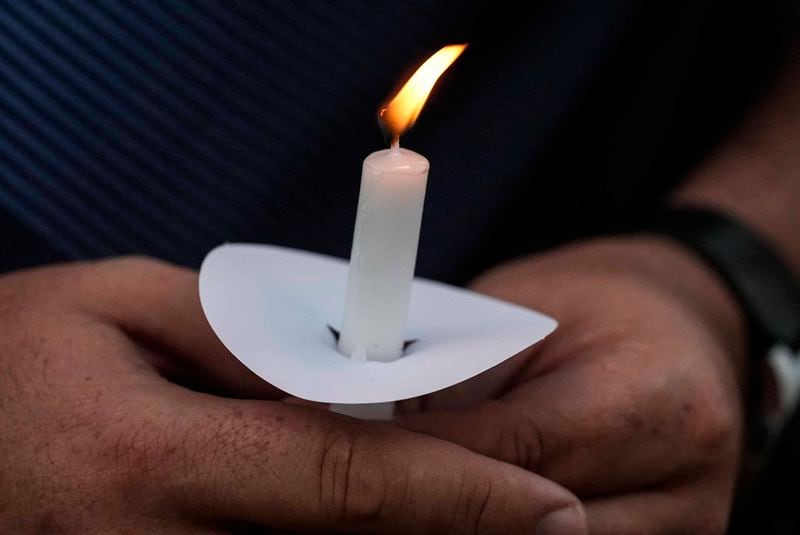 Mark Gorman holds a candle during a candlelight vigil for the slain students and teachers at Apalachee High School on Wednesday, Sept. 4, 2024, in Winder, Ga. (AP Photo/Mike Stewart)