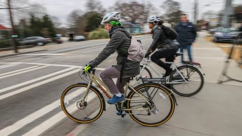 Bike riders enter the intersection at 10th and Monroe Drive from the Beltline, where a developer has proposed building a hotel and residences on four acres. JOHN SPINK /JSPINK@AJC.COM AJC FILE PHOTO