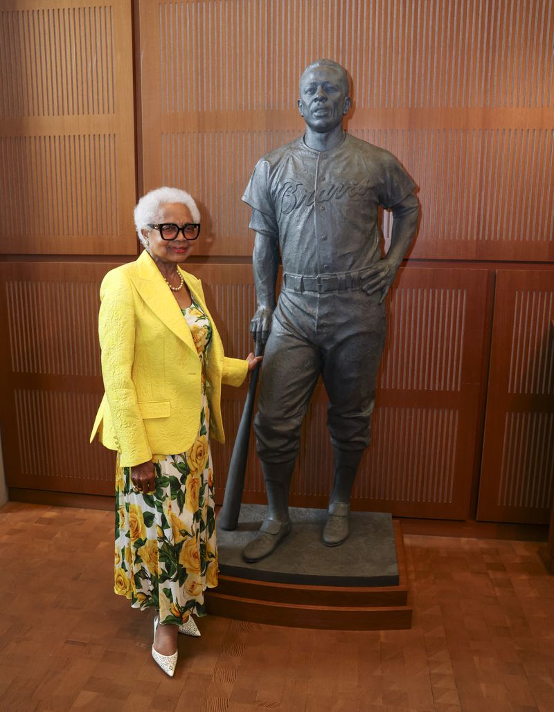 Billye Aaron, Hank Aaron’s widow, stands next to the Hank Aaron statue by the grand staircase at the National Baseball Hall of Fame, Thursday, May 23, 2024, in Cooperstown, NY. (Jason Getz / AJC)
