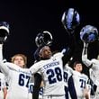 Camden County players salute their fans after beating McEachern 25-0 during a playoff game Friday, Nov. 17, 2023 at McEachern High School. (Daniel Varnado/For the AJC)