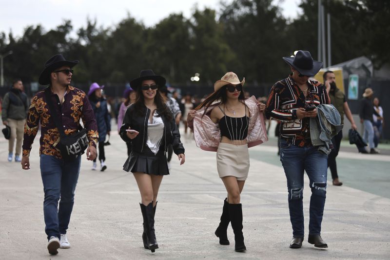 FILE - Fans arrive to the Arre Music Festival which showcases regional Mexican music, in Mexico City, Sept. 7, 2024. (AP Photo/Ginnette Riquelme, File)