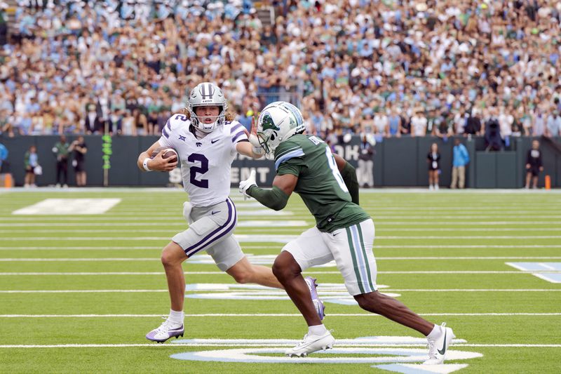 Kansas State quarterback Avery Johnson (2) stiff-arms Tulane defensive back Johnathan Edwards (8) during the first half of an NCAA college football game in New Orleans, Saturday, Sept. 7, 2024. (AP Photo/Matthew Hinton)