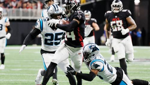 Falcons wide receiver Damiere Byrd (14) breaks a tackle as he approaches the end zone against the Carolina Panthers in Atlanta.  Miguel Martinez / miguel.martinezjimenez@ajc.com