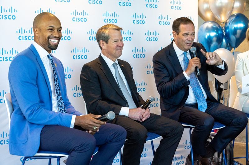 (L-R) Donald Beamer Jr., senior technology officer with the Mayor’s Office; Gov. Brian Kemp; and Chuck Robbins, CEO of Cisco, appear on a panel at Cisco’s new office space at Coda in Atlanta on Tuesday, April 11, 2023. (Arvin Temkar / arvin.temkar@ajc.com)