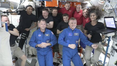 In this image made from a NASA livestream, the two astronauts stuck at the International Space Station since June 2024, Butch Wilmore, far left, and Suni Williams, far right, welcome two new residents who flew up on SpaceX, NASA's Nick Hague, front left in blue, and the Russian Space Agency's Alexander Gorbunov, front right in blue, Sunday, Sept. 29, 2024. Behind them, from left in black, are NASA's Jeanette Epps, Russia's Alexander Grebenkin, NASA's Mike Barratt and NASA's Matthew Dominic. From left, wearing red, are Russia's Ivan Vagner, NASA's Don Pettit and Russia's Alexei Ovchinin. (NASA via AP)